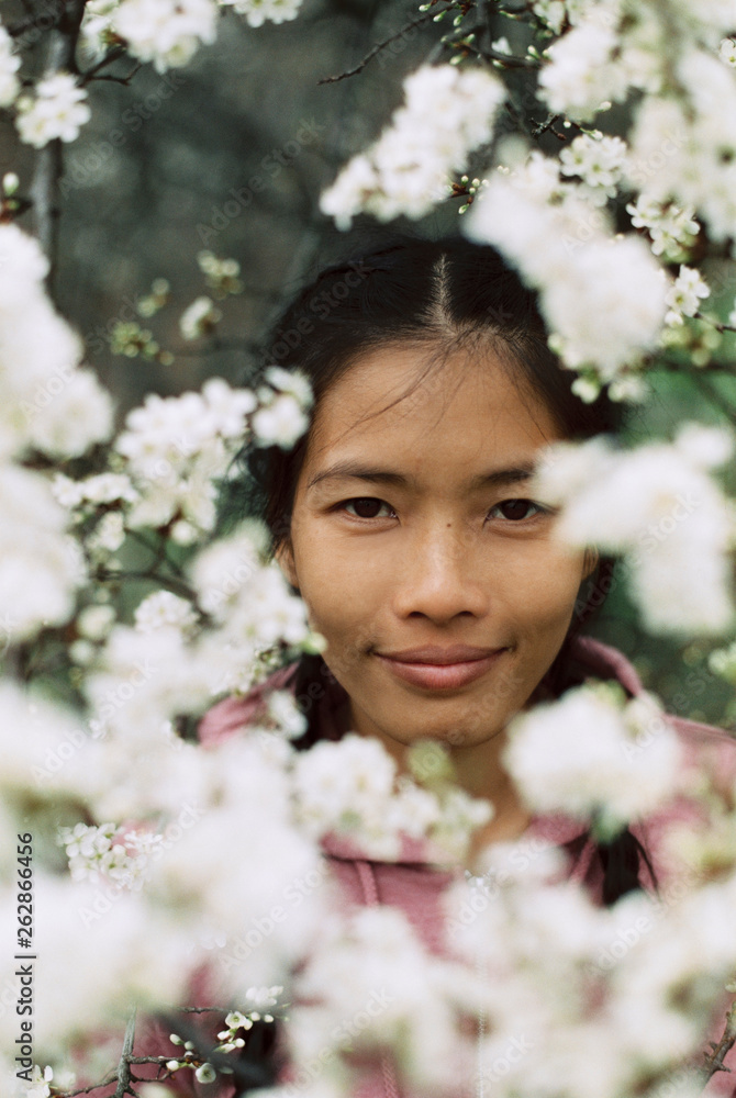 Portrait of asian woman in tree blossom Portrait of asian woman in tree blossom