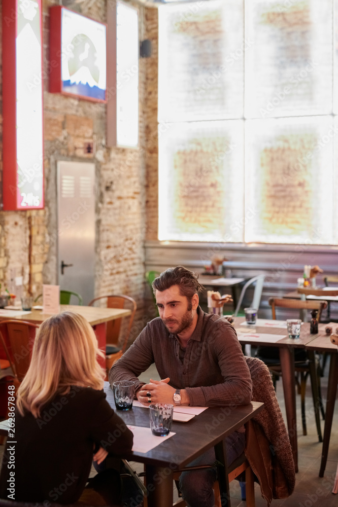 Couple sitting in restaurant. Couple sitting in restaurant.