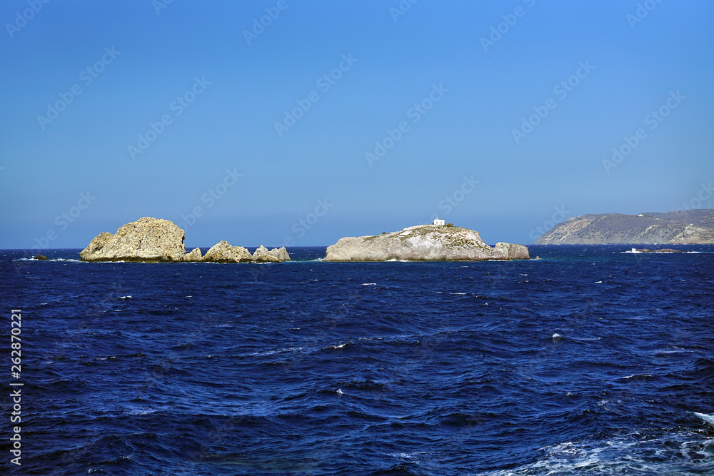 sea landscape and cliffs with a small solitary church near the island of Paros