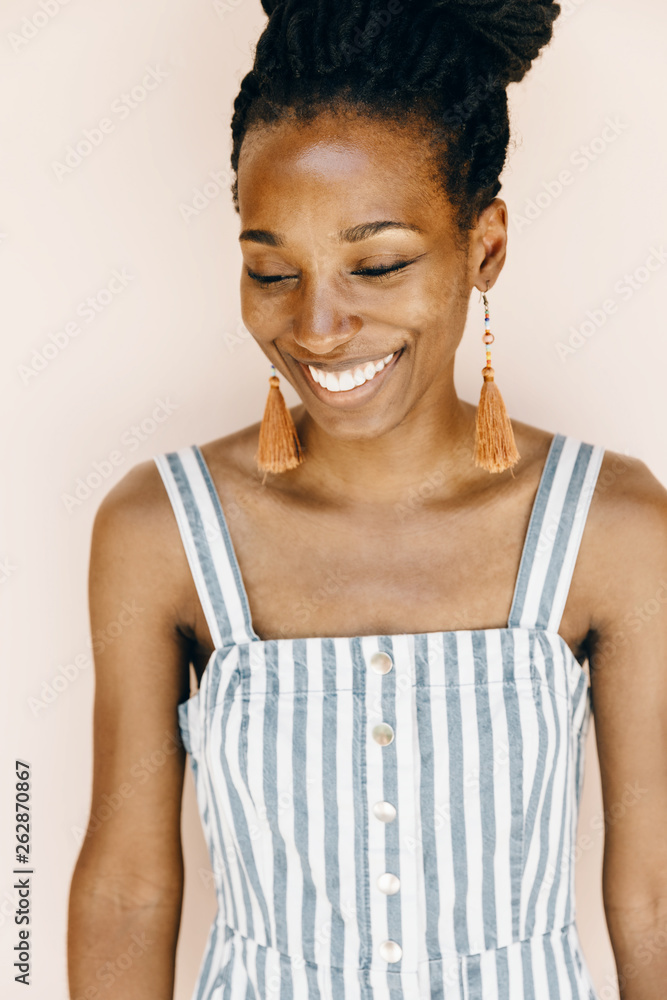 © Andrey Pavlov/Stocksy - Beautiful african american woman smiling