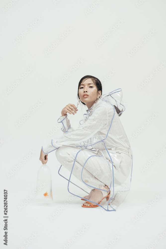 Female in white fashionable outfilt with goldfish. Female in white fashionable outfilt with goldfish.