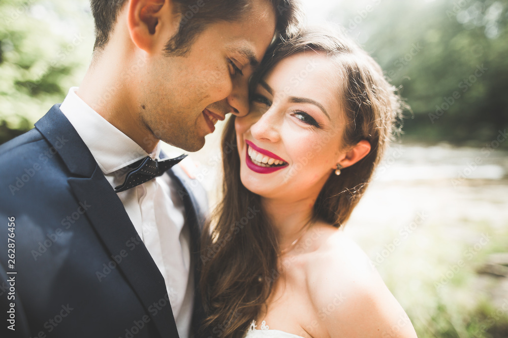 Beautiful, perfect happy bride and groom posing on their wedding day. Close up portrait Beautiful, perfect happy bride and groom posing on their wedding day. Close up portrait