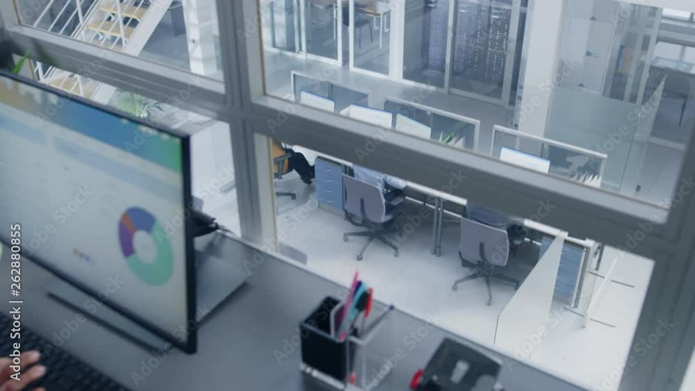 Camera Moving From Open Space Office People Working at their Desktop Computers to Businesswoman Using Computer with Graphs and Statistics. Businesspeople Working of First Floor and Executive on Second Camera Moving From Open Space Office People Working at their Desktop Computers to Businesswoman Using Computer with Graphs and Statistics. Businesspeople Working of First Floor and Executive on Second
