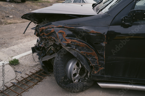 Car after collision. A close up of a broken car after a traffic accident. Crumpled side of a car as a result of a clash. 