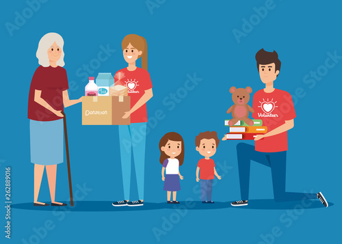 girl and boy volunteers with old woman and kids to donation
