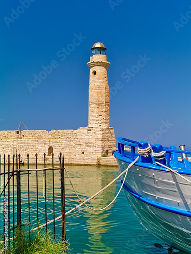 Wallpaper Mural Rethymno port lighthouse and white blue boat. Bright summer day. Torontodigital.ca