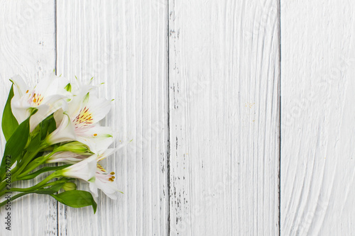 Flat lay with White lilies on a old white wooden background