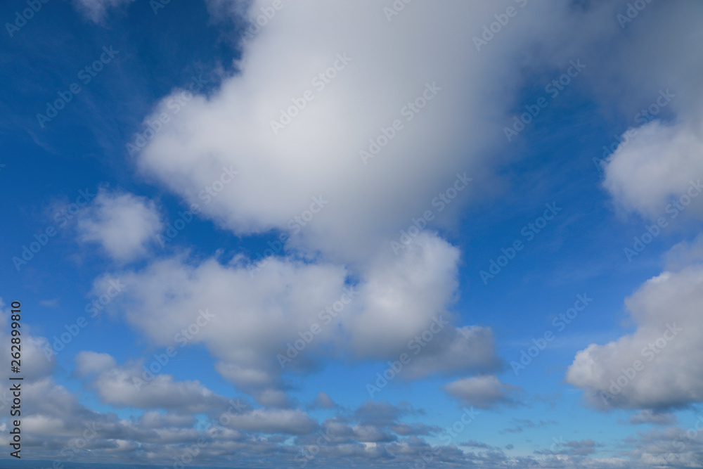 blue sky with white clouds to horizon
