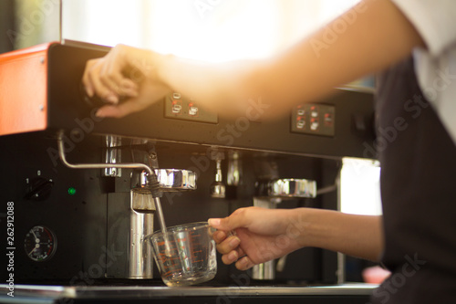 Employees working with coffee makers.