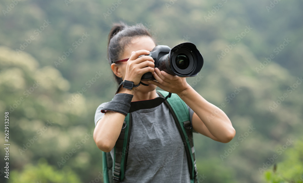 woman photographer taking photo on spring forest mountain