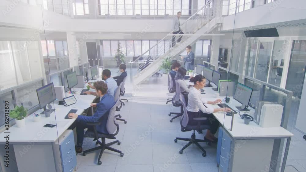 Diverse Multinational Team of Business Managers and Specialists Work on Desktop Computers, Have Discussion with Colleagues. Young and Motivated Business people in Modern Open Office. Diverse Multinational Team of Business Managers and Specialists Work on Desktop Computers, Have Discussion with Colleagues. Young and Motivated Business people in Modern Open Office.