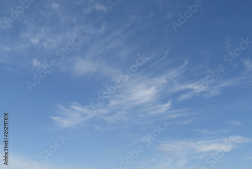 The real blue sky with a few white cirrous clouds photo