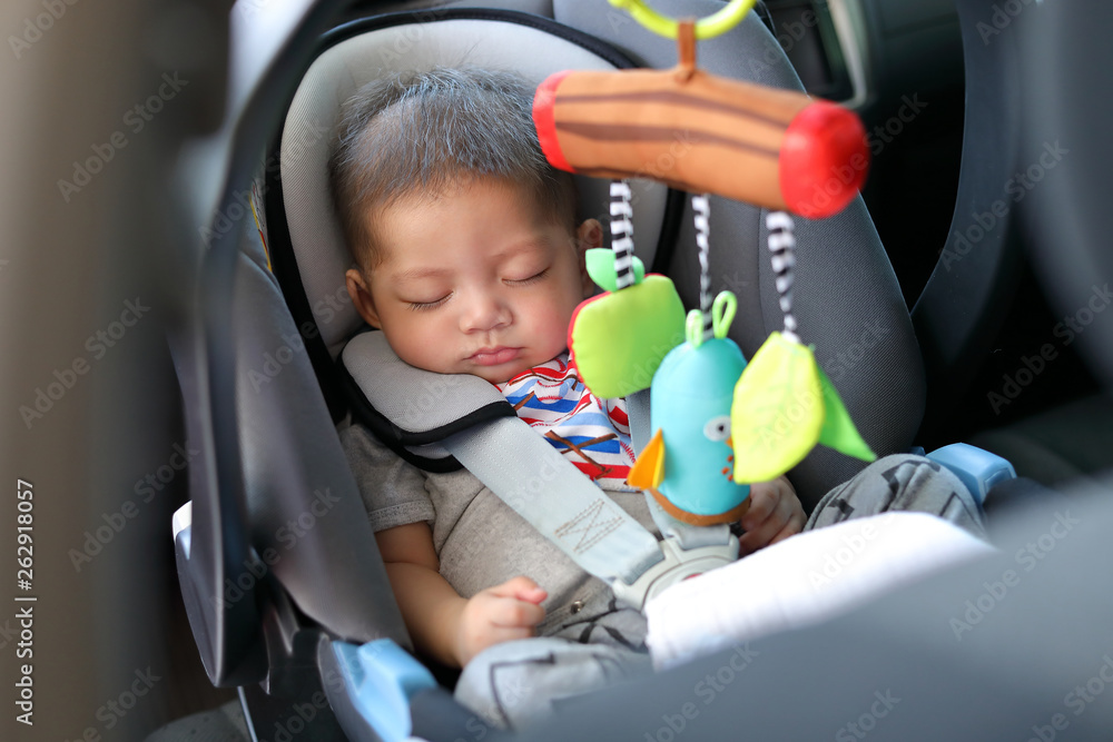 cute baby boy sleeping in car seat safety belt lock protection drive road trip