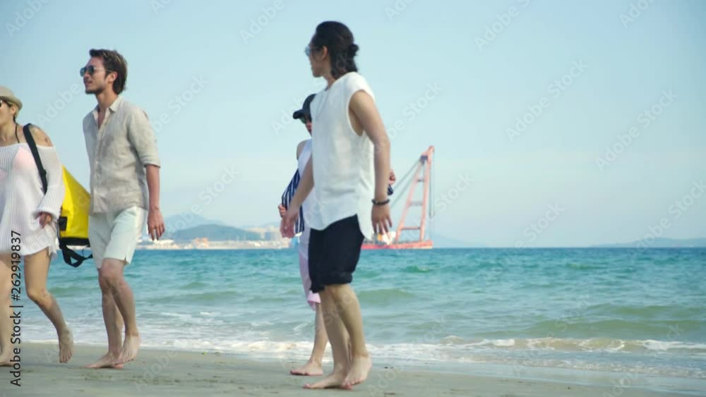 young asian adults having fun walking on beach young asian adults having fun walking on beach