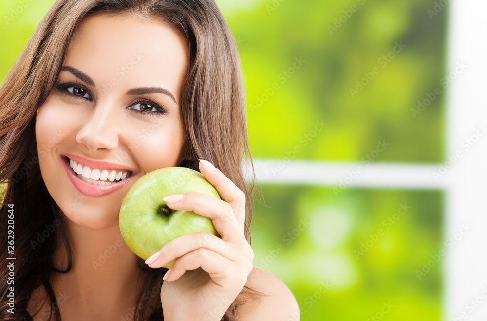 Young lovely woman with green apple, outdoors Young lovely woman with green apple, outdoors