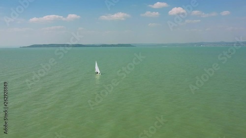 Afternoon drone view from a little sailboat near the shore of Zamárdi, Lake Balaton. ( DJi Drone footage I 29.97 fps ) photo