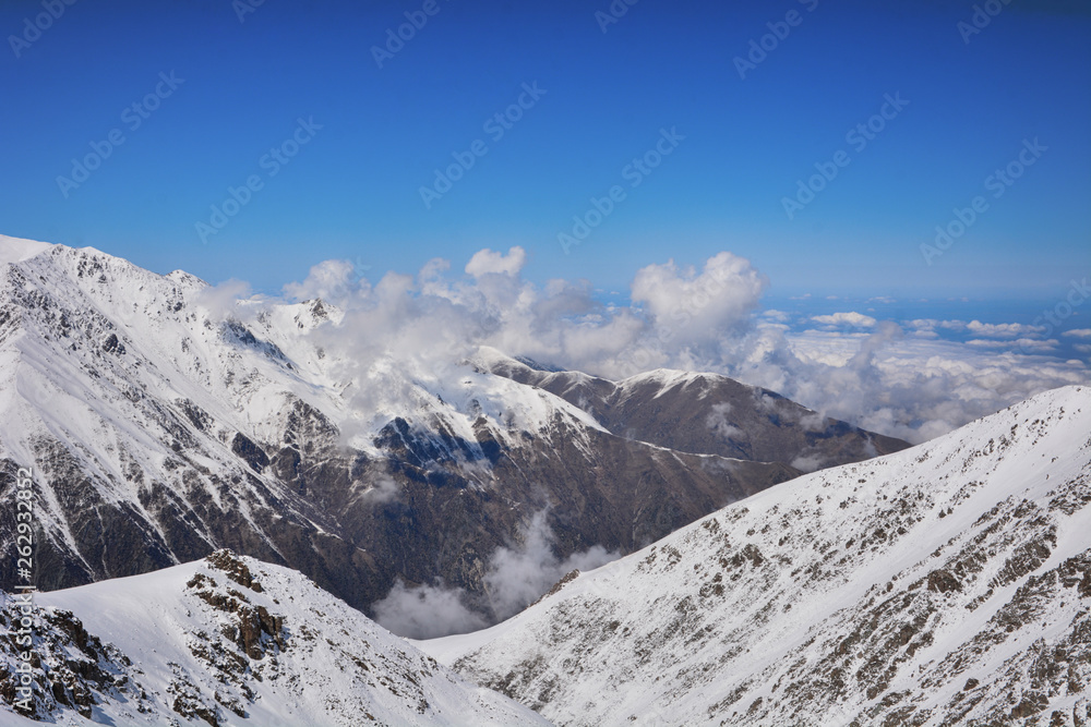Mountains ranges with stunning cloudscapes, sand and rock formations.