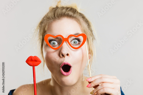 woman holds carnival accessories on stick