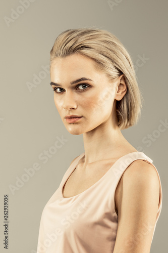 Nice serious young woman looking at you