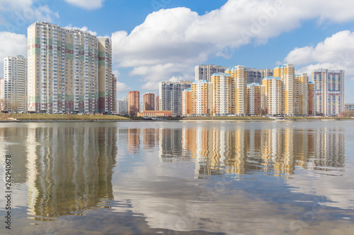 High-rise buildings on the river bank with reflection, Moscow, Russia
