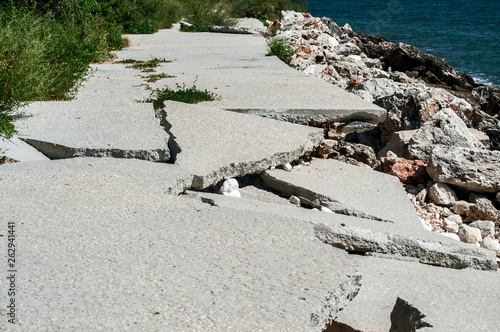 Destroyed by sea water erosion process seaside promenade concrete cover surface