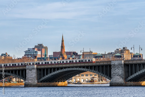 Scene of Train running over the Longfellow Bridge the charles river at the evening time  USA downtown skyline  Architecture and building with transportation concept