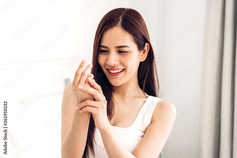 Beautiful woman beauty health care.beauty and spa.perfect fresh skin.woman touch her arm on the bed at home Beautiful woman beauty health care.beauty and spa.perfect fresh skin.woman touch her arm on the bed at home