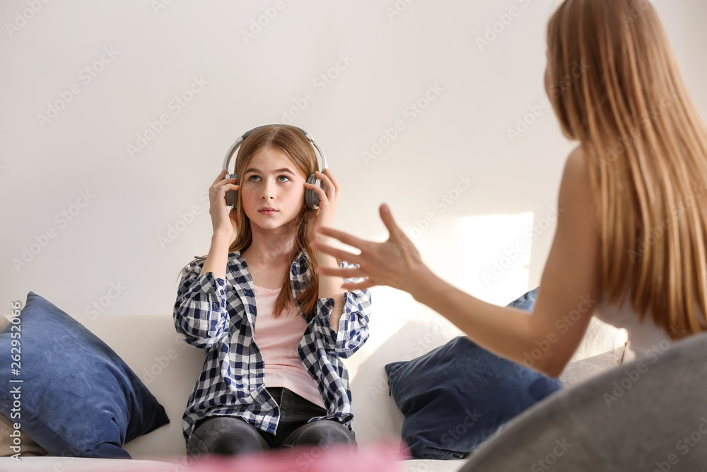 Sad teenage girl having argument with her mother at home Sad teenage girl having argument with her mother at home
