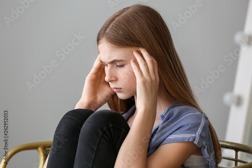 Sad teenage girl at home