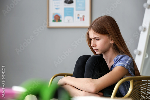 Sad teenage girl at home