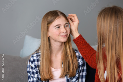 Cute teenage girl with moth...