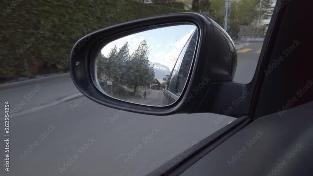 View of the side mirror of a car during driving View of the side mirror of a car during driving