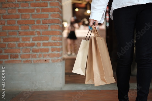 Young woman holding sale shopping bags. consumerism lifestyle concept in the shopping mall