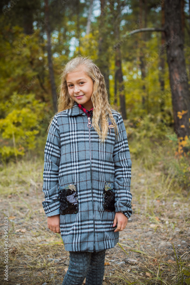 Little fashionable girl in warm clothes walk outdoor, Autumn - Winter season, holidays and children concept. Sweet girl at European street Little fashionable girl in warm clothes walk outdoor, Autumn - Winter season, holidays and children concept. Sweet girl at European street