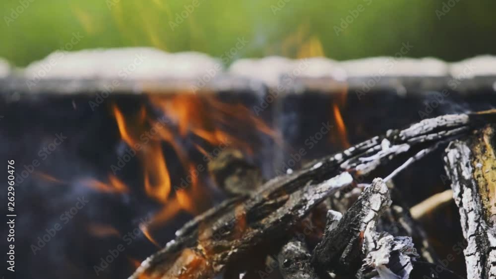 Afternoon in and out of focus and closer view footage from a wood pile which is burning and smokes. Afternoon in and out of focus and closer view footage from a wood pile which is burning and smokes.