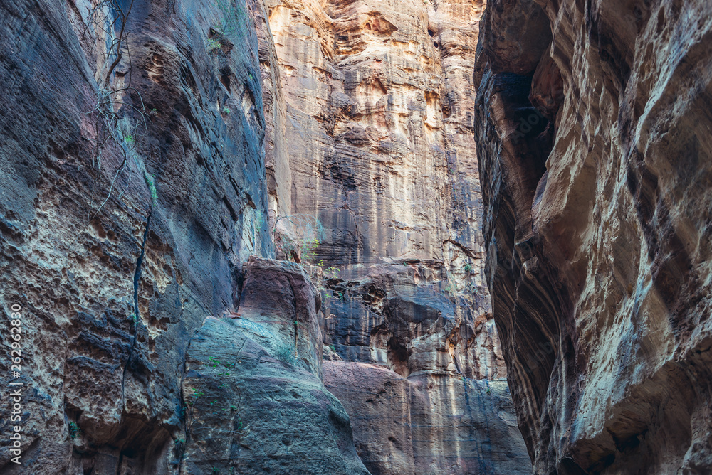Rocky walls of so called Siq passage in ancient Petra city in Jordan