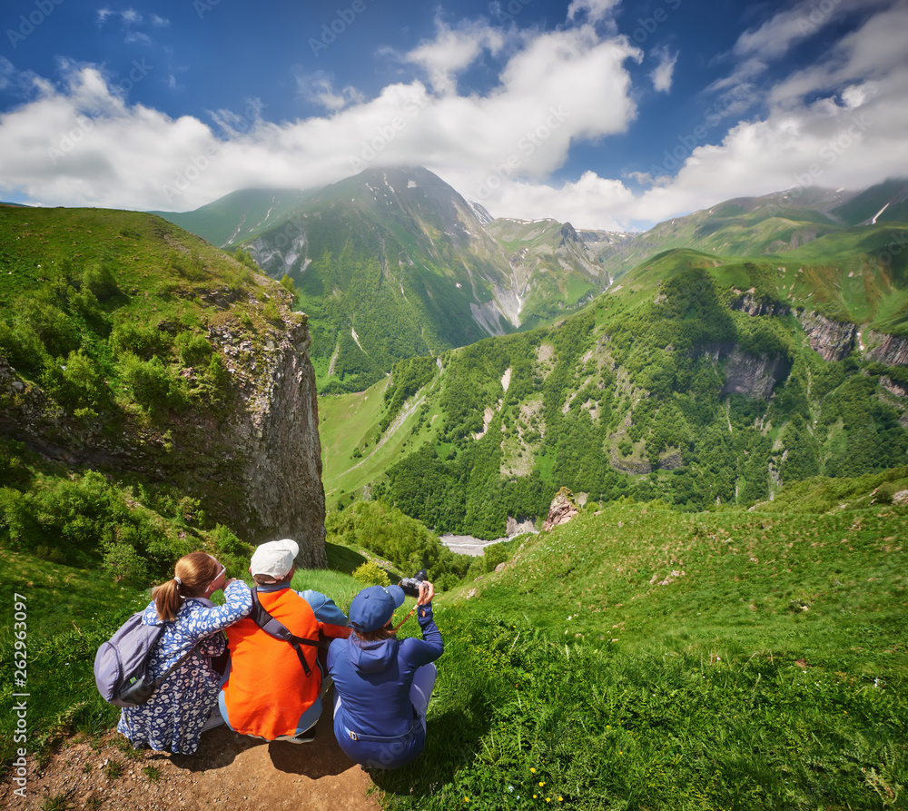 Group of tourists enjoying view mountains during summer vacation