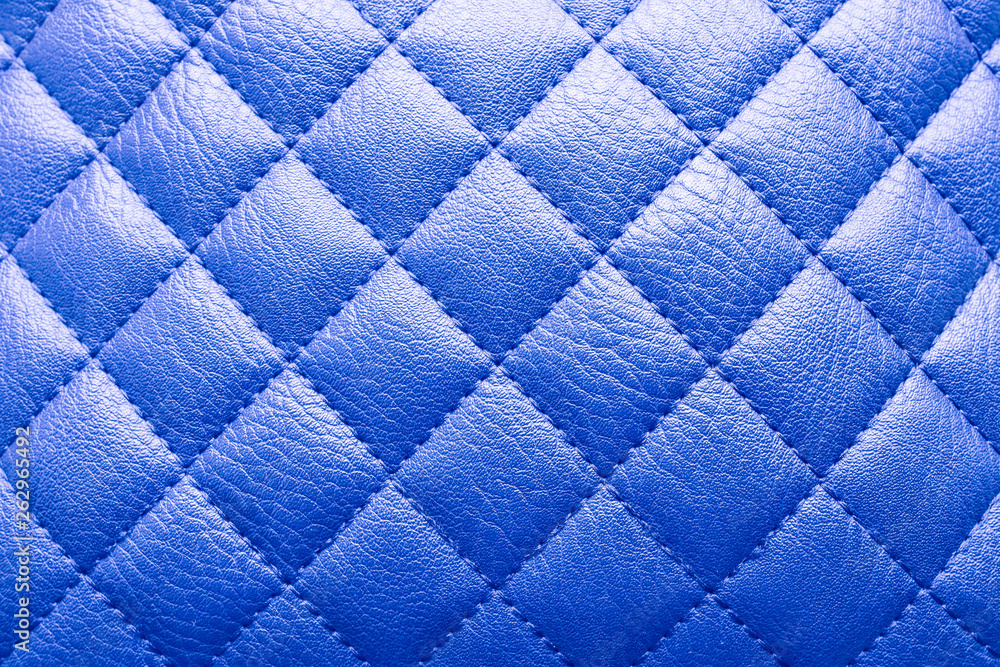 Fototapeta premium Proton purple colored leather texture with rhombus. Background for sofa interior or door.
