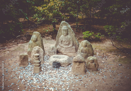 Statue in Kinkaku-ji temple garden, Kyoto, Japan