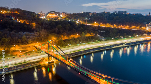 aerial night city view, luminous buildings and bridge. Drone shot
