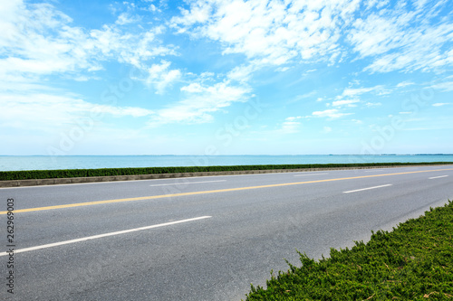Empty asphalt road and sea with beautiful clouds © ABCDstock