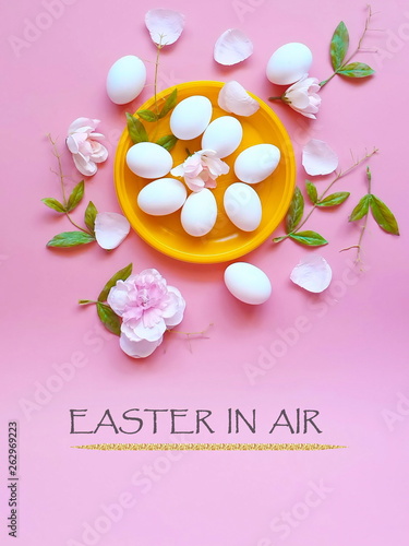 White Eggs on Yellow plate flowers  On Pink Background Ester Holiday Background Concept photo