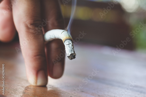 Man hand with burning cigarette as penis in smoking cause sexual erectile dysfunction,  tobacco causes to Erectile dysfunction photo