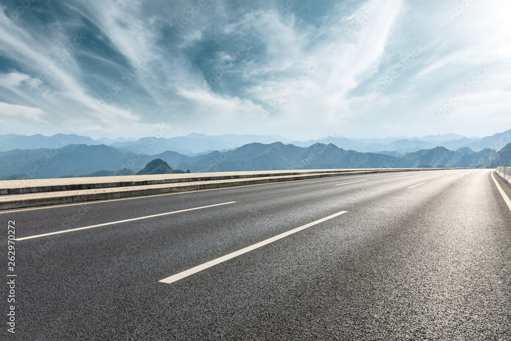 Empty asphalt road and mountains with beautiful clouds landscape Empty asphalt road and mountains with beautiful clouds landscape