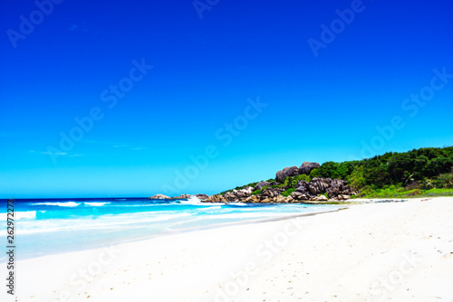 Fototapeta Naklejka Na Ścianę i Meble -  White sand, palm trees, granite rocks and turquoise water at the paradise beach at grand anse, la digue, seychelles 3