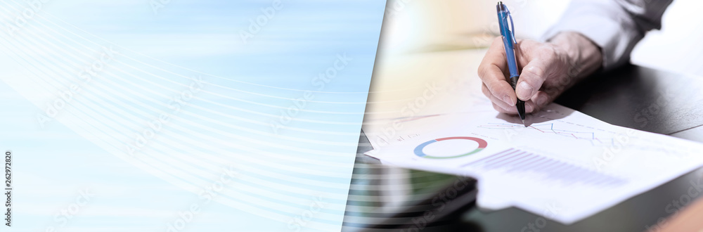 Businessman analyzing graphics, light effect. panoramic banner Businessman analyzing graphics, light effect. panoramic banner