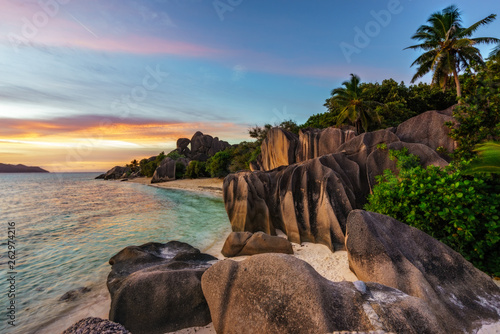 sunset over rocks,sand,palms,turquoise water at tropical beach,la dique,seychelles paradise 2 © Christian B.