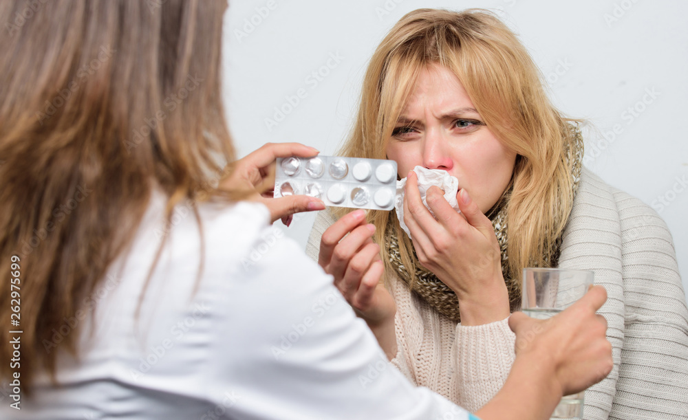 Handing over the drugs. Doctor visiting unhealthy woman at home. Patient care and healthcare. Medical doctor examining patient. Primary care doctor making diagnosis to sick woman Handing over the drugs. Doctor visiting unhealthy woman at home. Patient care and healthcare. Medical doctor examining patient. Primary care doctor making diagnosis to sick woman