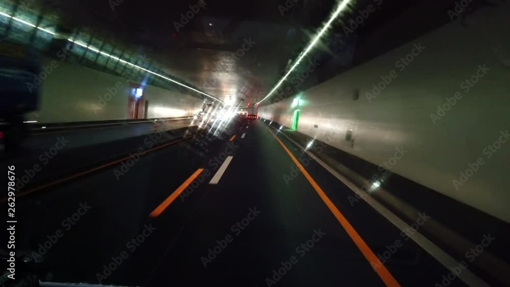 A car is driving in a tunnel and turns on the windscreen wipers. It is raining. A car is driving in a tunnel and turns on the windscreen wipers. It is raining.
