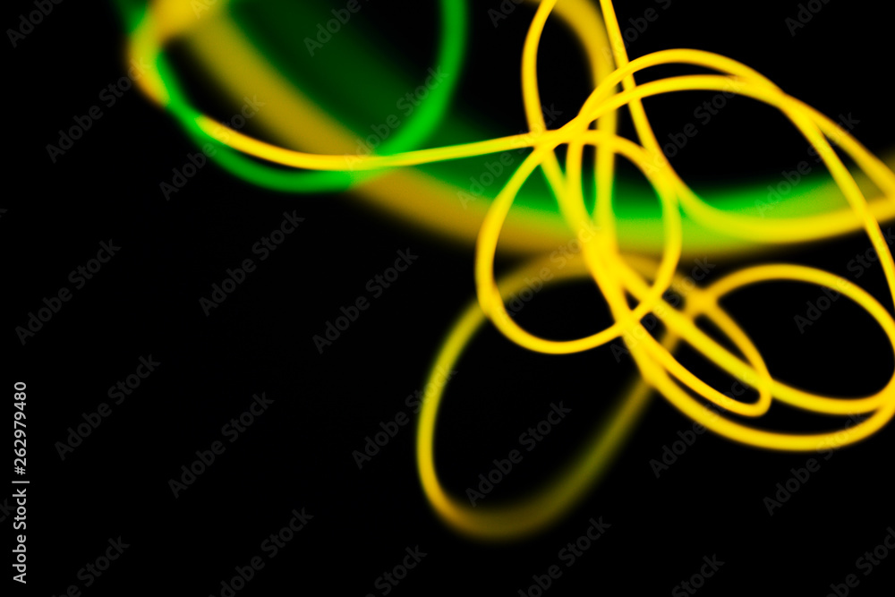 Yellow neon and green neon abstract. Neon lines. Isolated on black background. Yellow neon and green neon abstract. Neon lines. Isolated on black background.